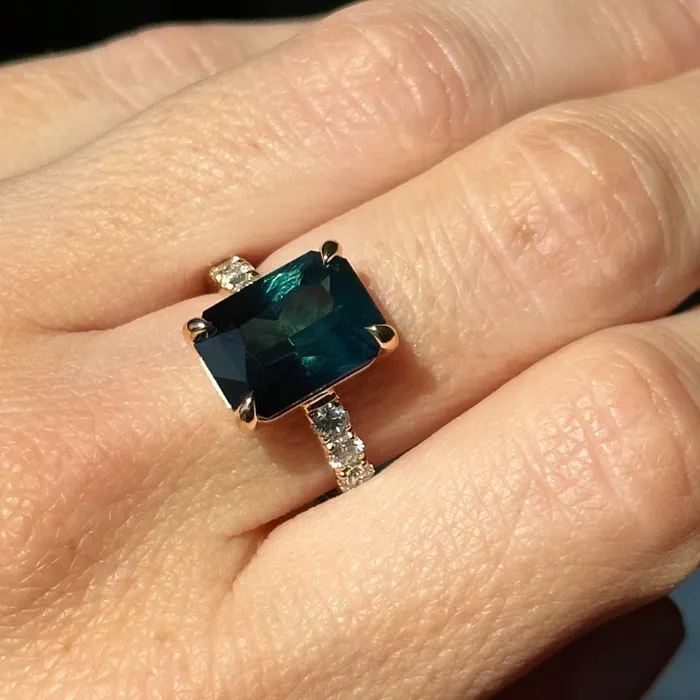 Rings 612ct Deep Teal Blue Madagascar Radiant Cut Sapphire Solitaire Ring with French Set Diamonds in 18k Yellow Gold Anueva Jewelry
