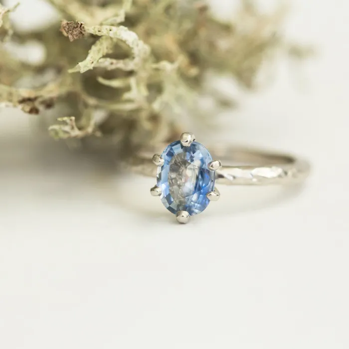 Rings Anueva Jewelry Light Periwinkle Blue Oval Sapphire Ring in Hand Carved Recycled Platinum Earthy Setting Sixprong Sapphire Engagement Ring by Anueva Jewelry Rings Anueva Jewelry Light Periwinkle Blue Oval Sapphire Ring in Hand Carved Recycled Platinum Earthy Setting Sixprong Sapphire Engagement Ring by Anueva Jewelry