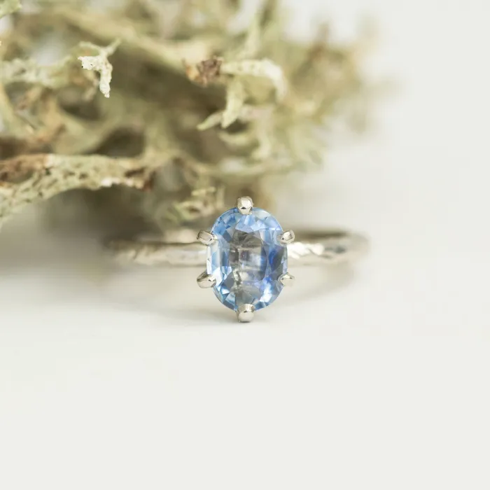 Rings Anueva Jewelry Light Periwinkle Blue Oval Sapphire Ring in Hand Carved Recycled Platinum Earthy Setting Sixprong Sapphire Engagement Ring by Anueva Jewelry Rings Anueva Jewelry Light Periwinkle Blue Oval Sapphire Ring in Hand Carved Recycled Platinum Earthy Setting Sixprong Sapphire Engagement Ring by Anueva Jewelry