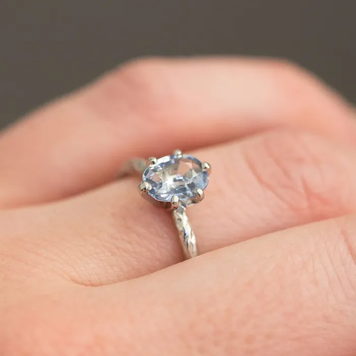 Rings Anueva Jewelry Light Periwinkle Blue Oval Sapphire Ring in Hand Carved Recycled Platinum Earthy Setting Sixprong Sapphire Engagement Ring by Anueva Jewelry Rings Anueva Jewelry Light Periwinkle Blue Oval Sapphire Ring in Hand Carved Recycled Platinum Earthy Setting Sixprong Sapphire Engagement Ring by Anueva Jewelry