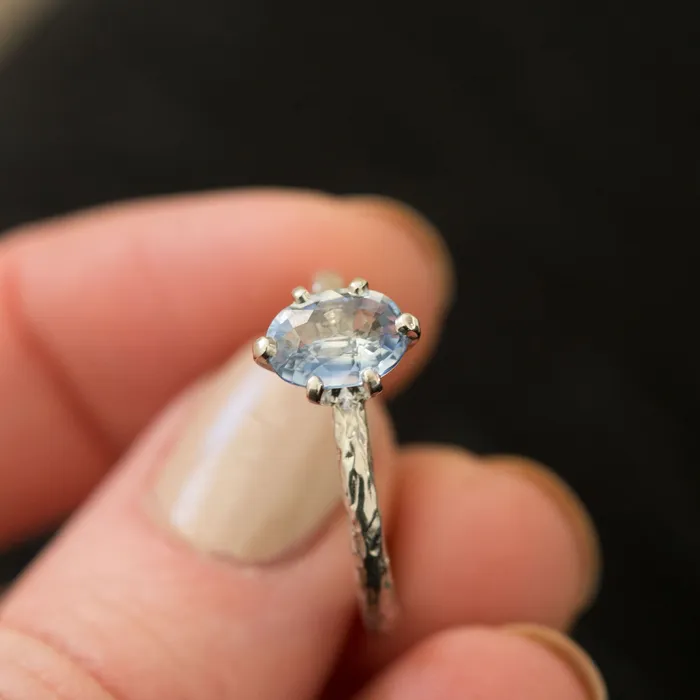 Rings Anueva Jewelry Light Periwinkle Blue Oval Sapphire Ring in Hand Carved Recycled Platinum Earthy Setting Sixprong Sapphire Engagement Ring by Anueva Jewelry Rings Anueva Jewelry Light Periwinkle Blue Oval Sapphire Ring in Hand Carved Recycled Platinum Earthy Setting Sixprong Sapphire Engagement Ring by Anueva Jewelry